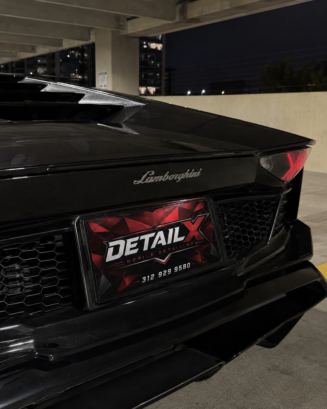 Lamborghini rear close-up with a DETAILX plate after service.