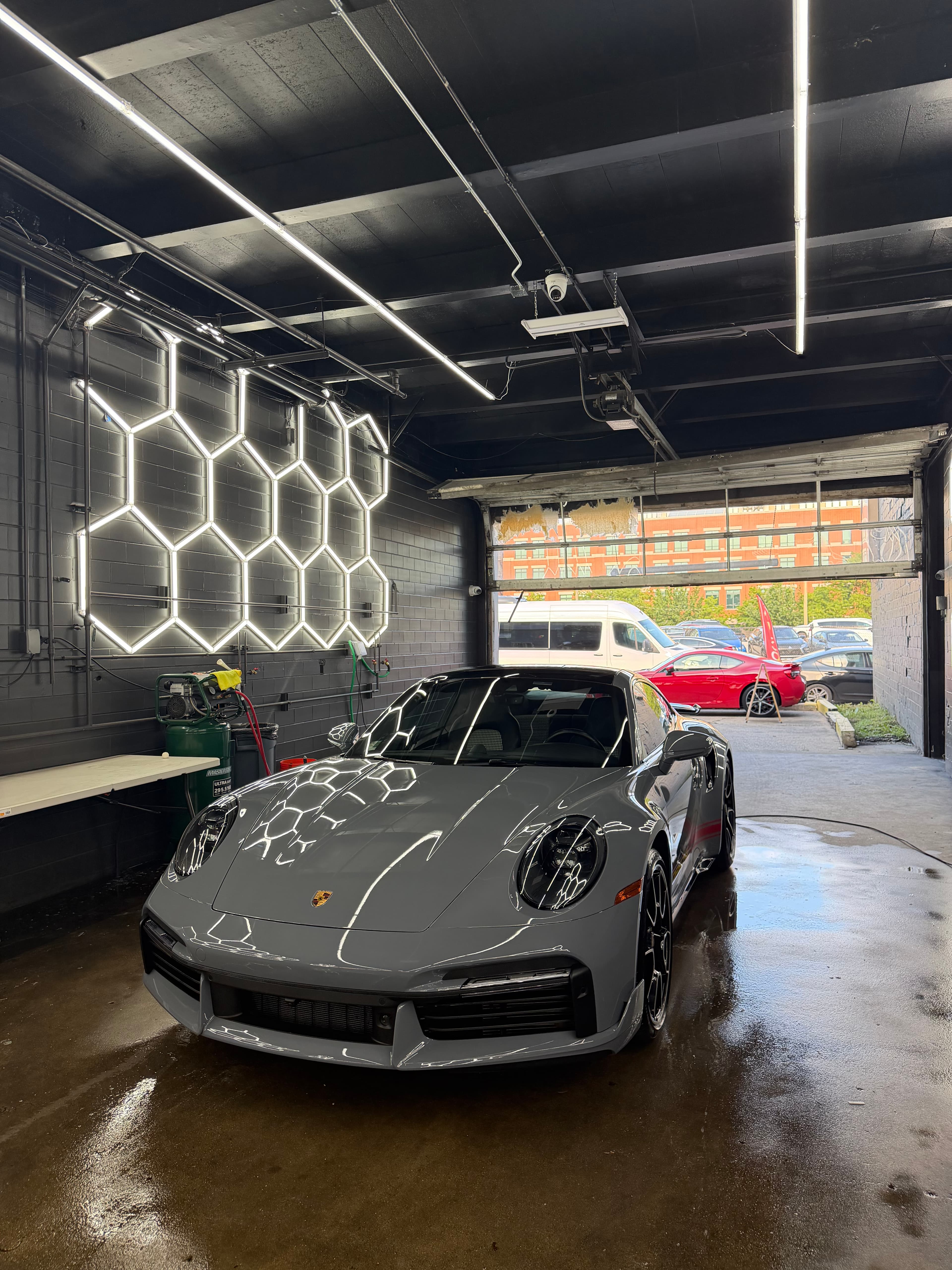 Grey Porsche 911 in the DETAILX detail bay after a premium detail.