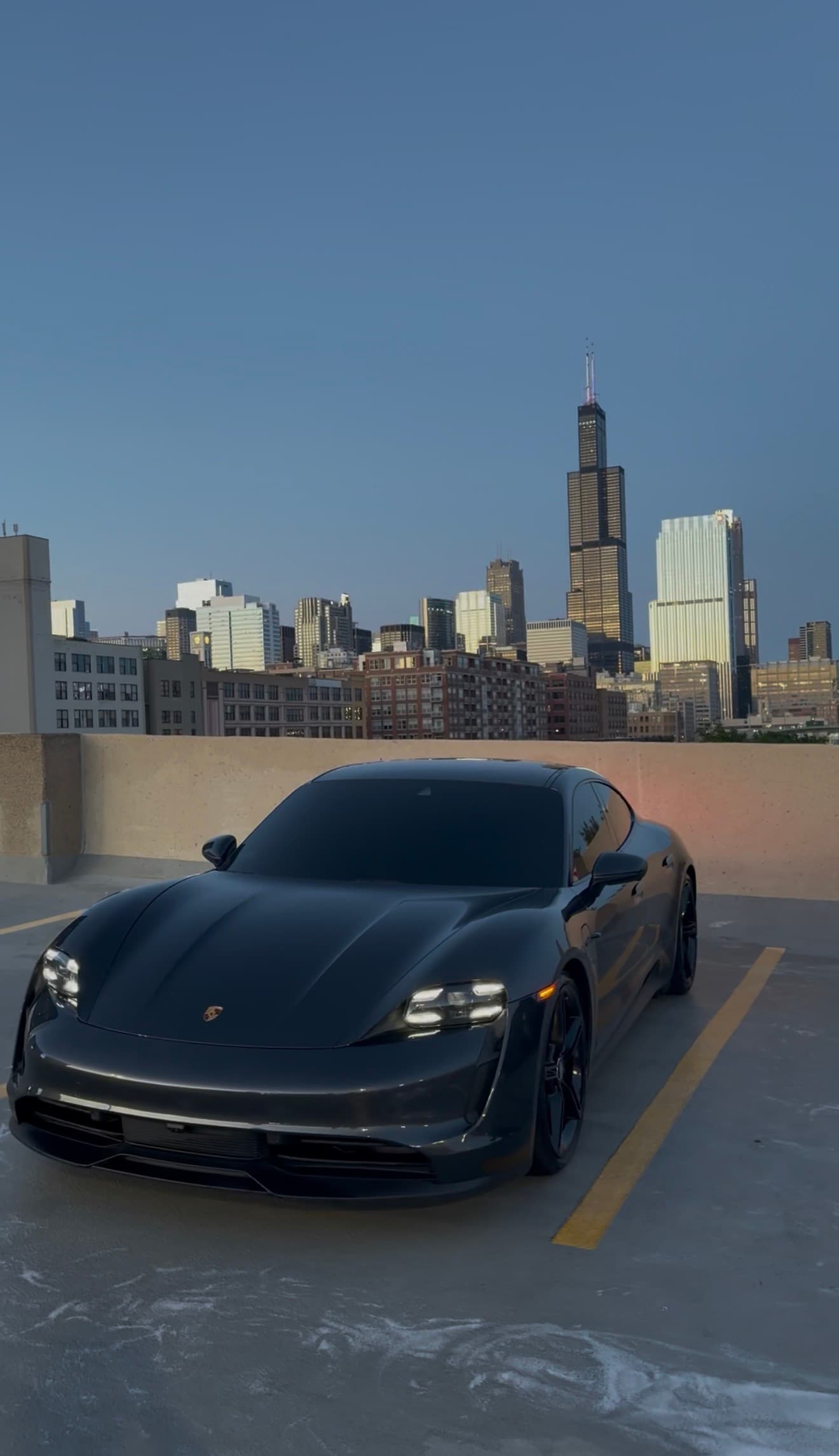 Porsche Taycan after a DETAILX Chicago mobile detail with the skyline in the background.