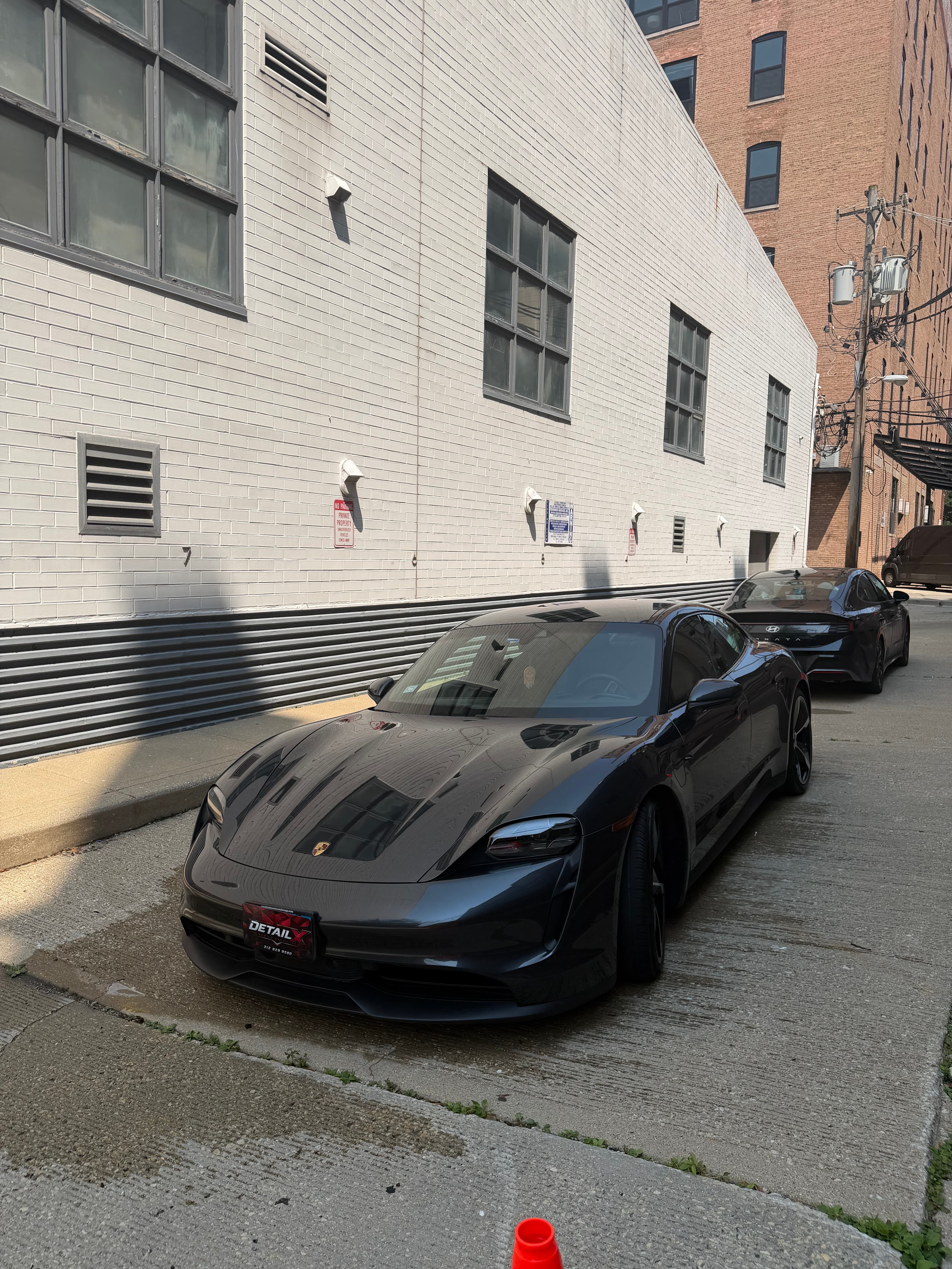 Porsche Taycan with DETAILX plate after a Chicago detail.