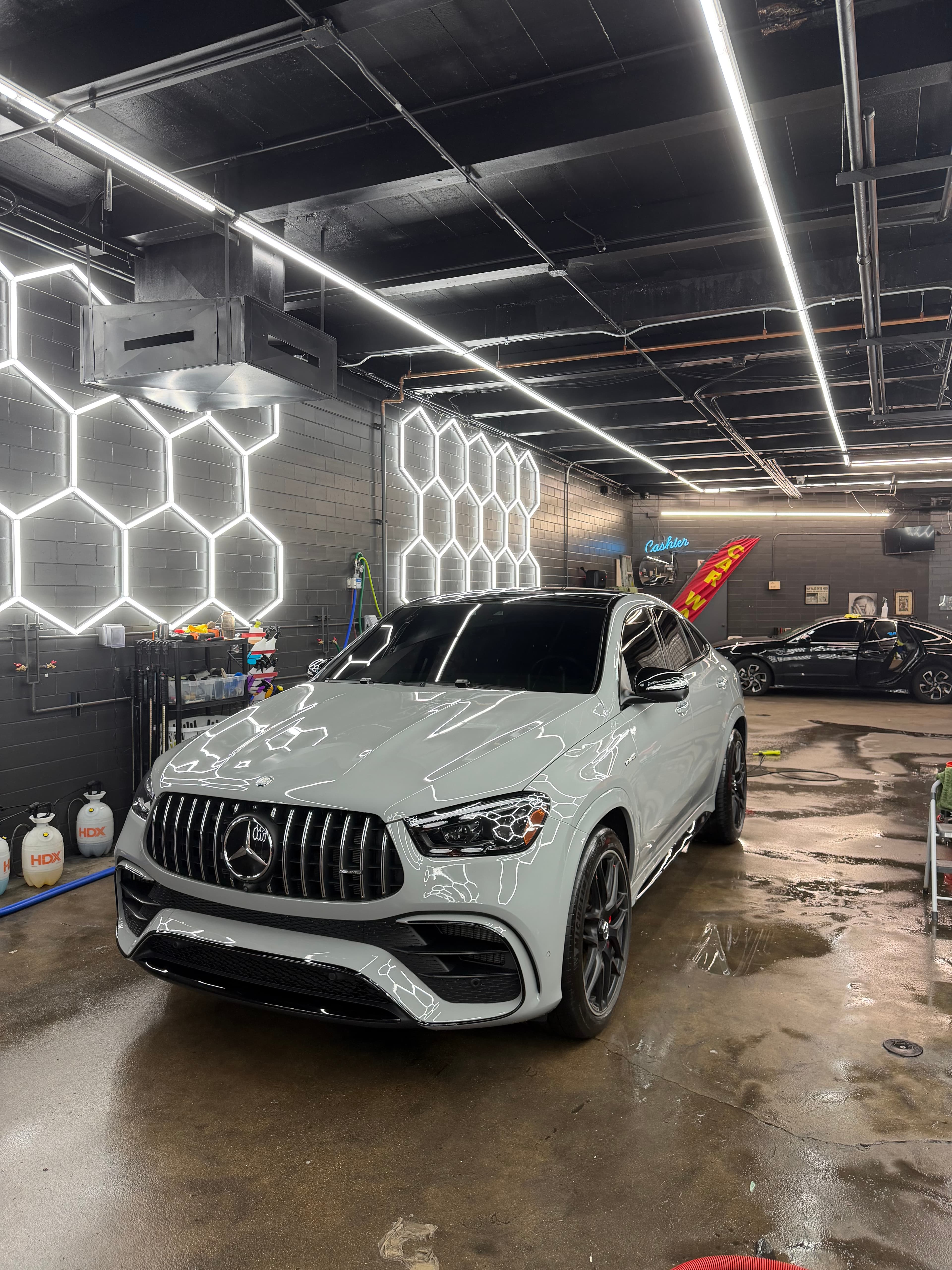 White Mercedes AMG SUV inside the DETAILX detail bay after service.